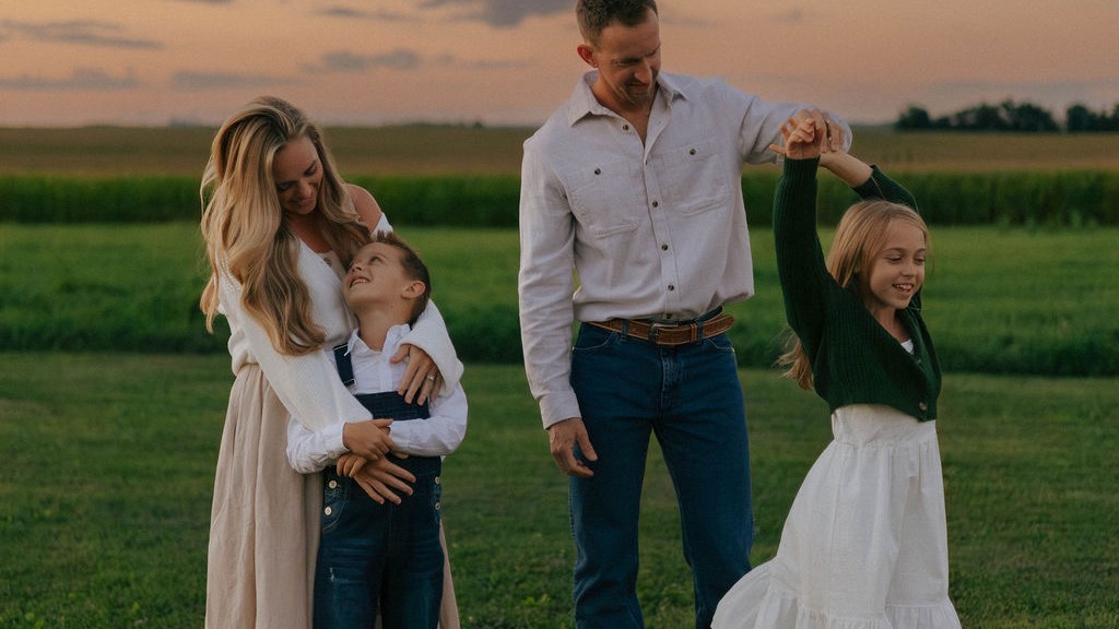 The Venture Seekers family, Brittany, Jake, Aniston and Noah, together in a Midwest field at golden hour